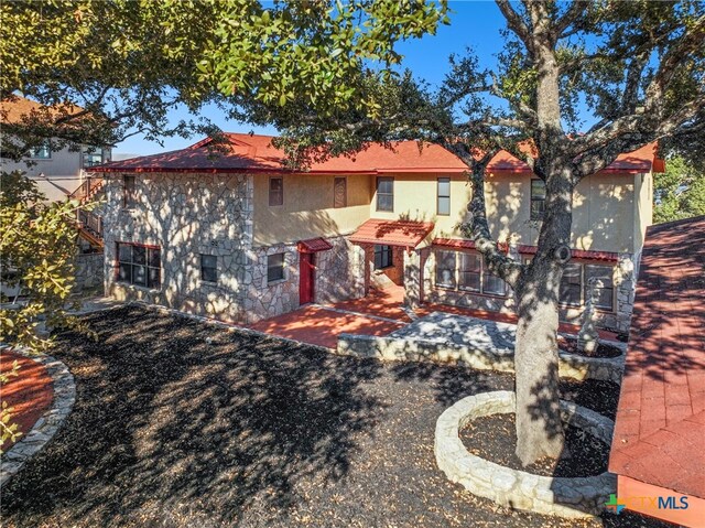 rear view of property featuring a patio