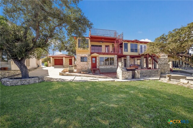 rear view of property with a balcony, central AC unit, and a lawn