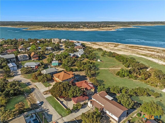 drone / aerial view featuring a beach view and a water view