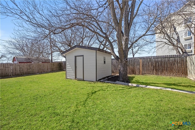 view of yard with an outbuilding, a storage unit, and a fenced backyard