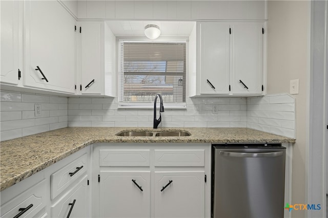 kitchen featuring white cabinets, a sink, and dishwasher