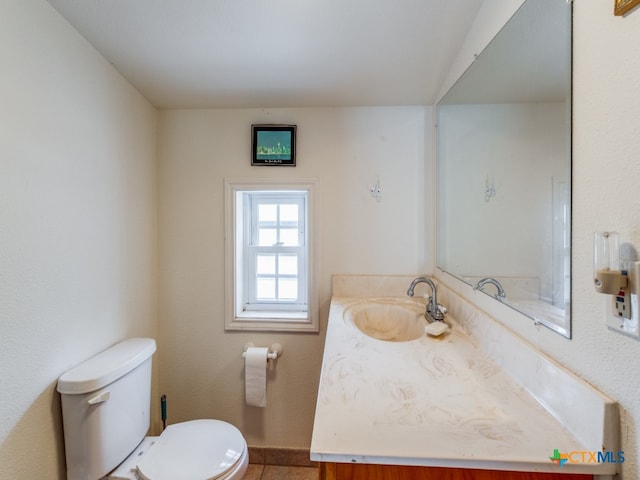 bathroom featuring toilet and vanity