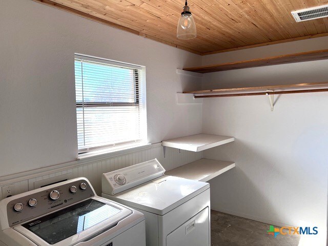 washroom featuring washer and dryer and wood ceiling