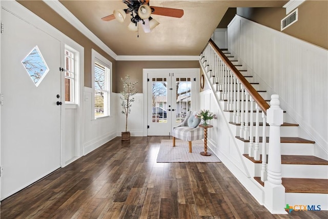 foyer featuring french doors, hardwood / wood-style flooring, visible vents, ornamental molding, and stairs