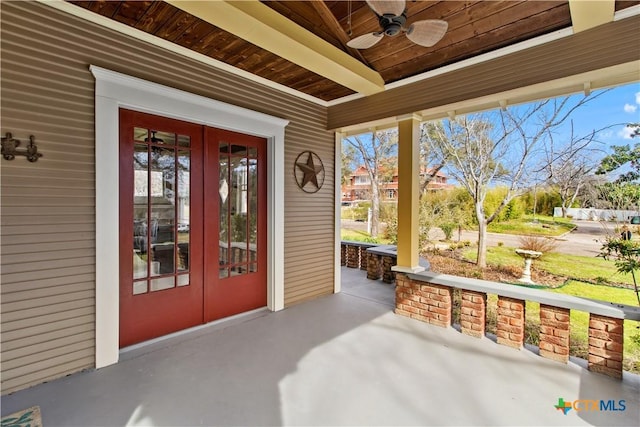 view of exterior entry with a patio area, a ceiling fan, and french doors