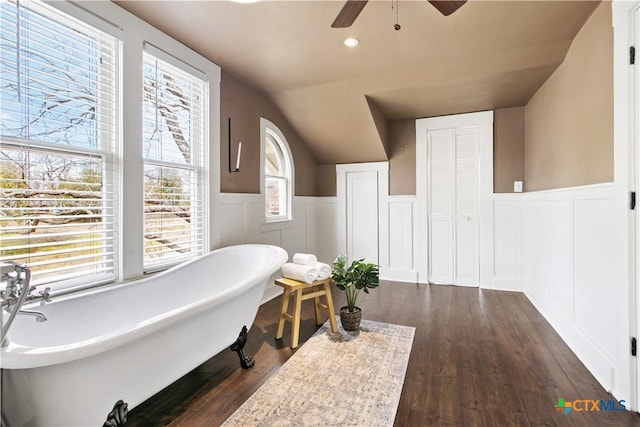 full bathroom with a wainscoted wall, recessed lighting, a soaking tub, ceiling fan, and wood finished floors