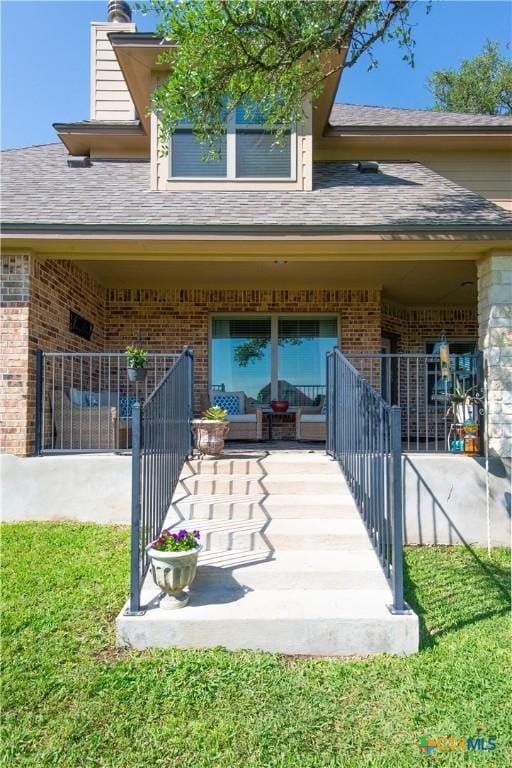 1729 Yturria Dr, Belton, TX 76513 - property entrance with brick siding, roof with shingles, and a chimney