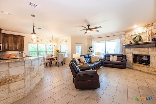 1729 Yturria Dr, Belton, TX 76513 - living area featuring ceiling fan, a fireplace, light tile patterned floors, and ornamental molding