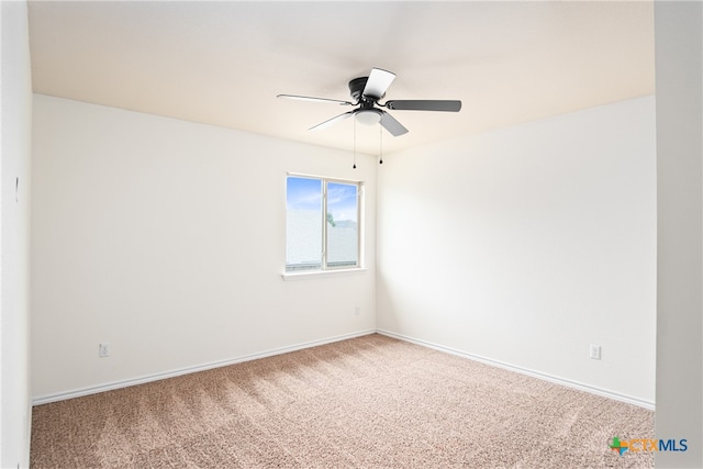 spare room featuring ceiling fan and carpet floors