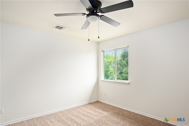 carpeted empty room featuring ceiling fan