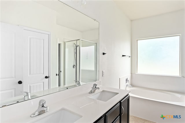 bathroom featuring vanity, plus walk in shower, and tile patterned flooring