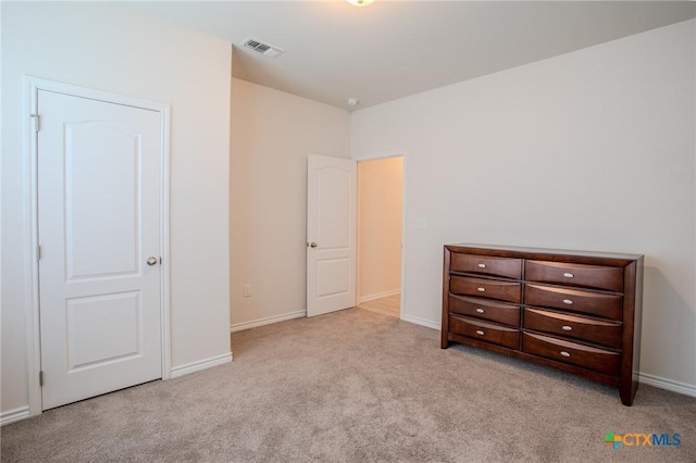 carpeted bedroom featuring visible vents and baseboards