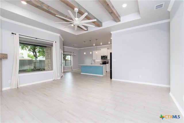 2904 Torino Reale Ave, Temple, TX 76502 - unfurnished living room featuring beam ceiling, ceiling fan, baseboards, a sink, and crown molding