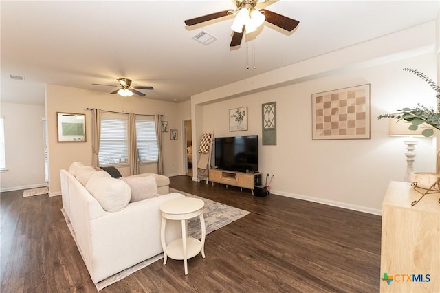 living room with ceiling fan and dark hardwood / wood-style flooring