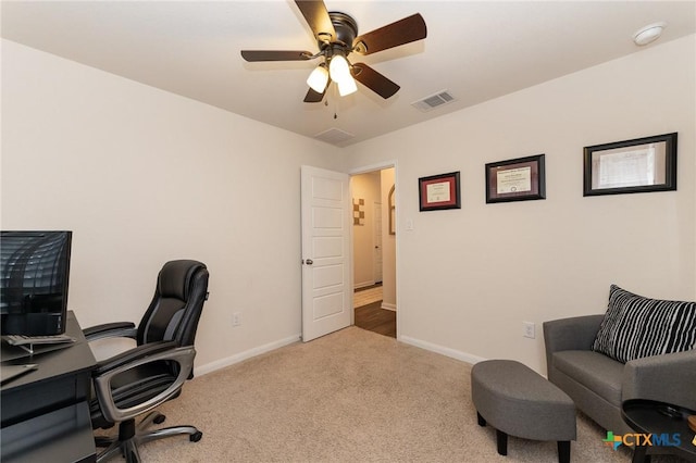 home office with ceiling fan and carpet floors