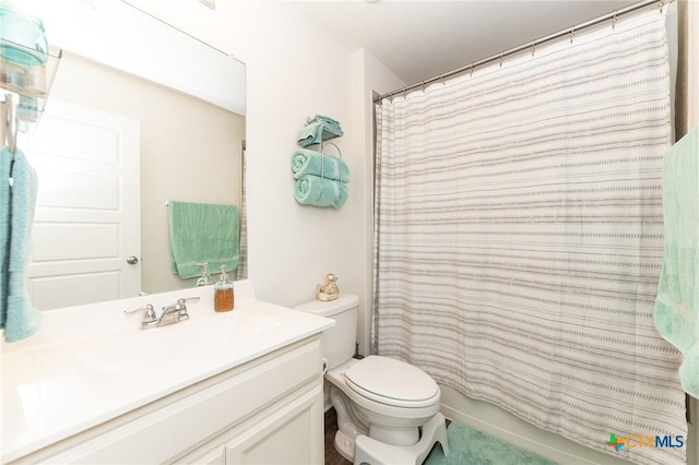 bathroom featuring vanity, toilet, and a shower with shower curtain