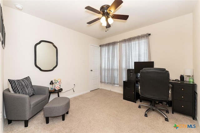 carpeted home office featuring ceiling fan