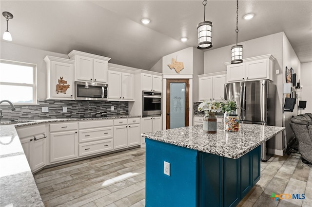 125 Savage Cir, Copperas Cove, TX 76522 - kitchen featuring stainless steel appliances, a sink, white cabinetry, decorative backsplash, and lofted ceiling