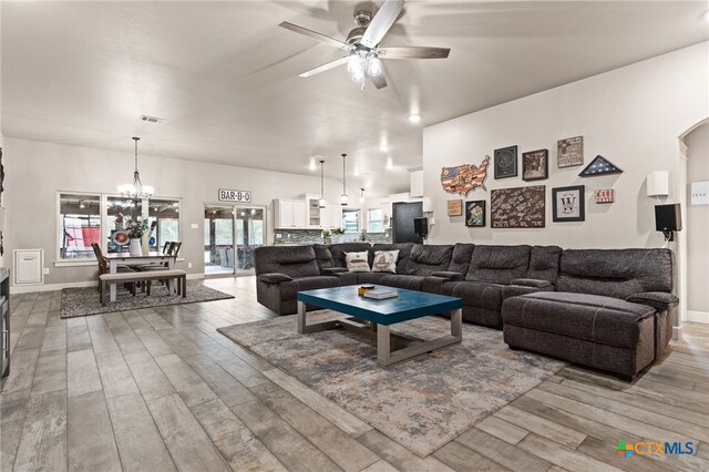 125 Savage Cir, Copperas Cove, TX 76522 - living room featuring ceiling fan, wood finished floors, a chandelier, and baseboards