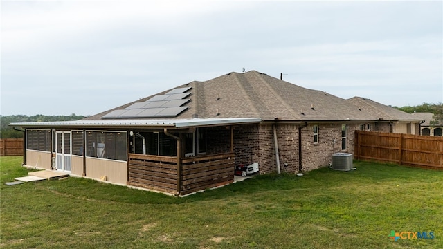 125 Savage Cir, Copperas Cove, TX 76522 - rear view of property featuring solar panels, a sunroom, central AC unit, and brick siding