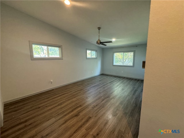 spare room featuring lofted ceiling, dark hardwood / wood-style floors, and ceiling fan