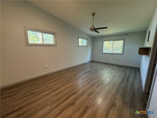 interior space with ceiling fan, dark hardwood / wood-style floors, and lofted ceiling