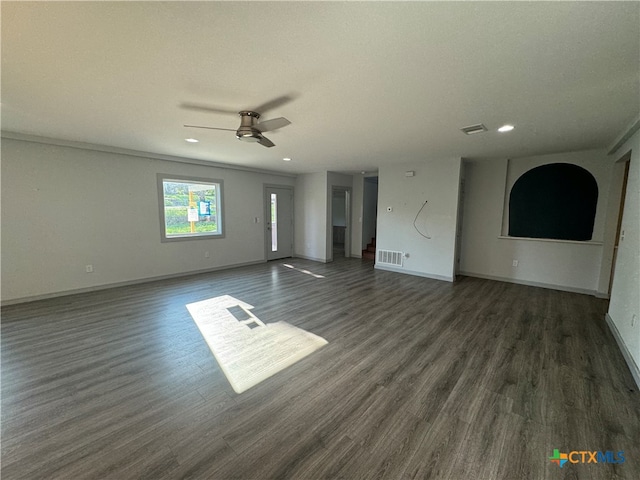 unfurnished living room with crown molding, dark hardwood / wood-style floors, and ceiling fan