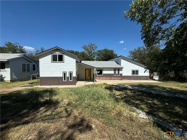 back of property featuring a lawn and a patio area