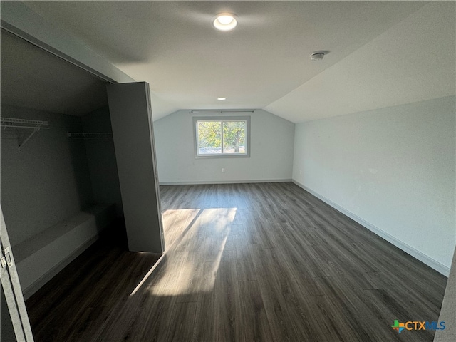 bonus room featuring lofted ceiling and dark hardwood / wood-style floors