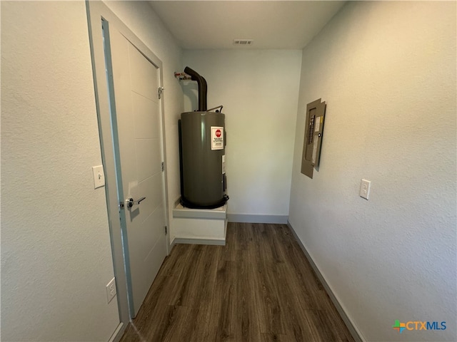 hallway featuring electric panel, water heater, and dark hardwood / wood-style flooring