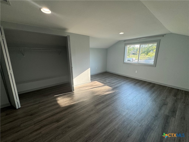 bonus room with dark hardwood / wood-style floors and lofted ceiling