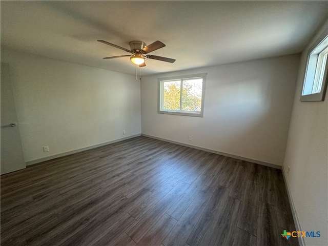 unfurnished room featuring ceiling fan and dark hardwood / wood-style flooring