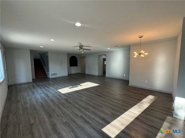 unfurnished living room with dark hardwood / wood-style floors, crown molding, and ceiling fan with notable chandelier