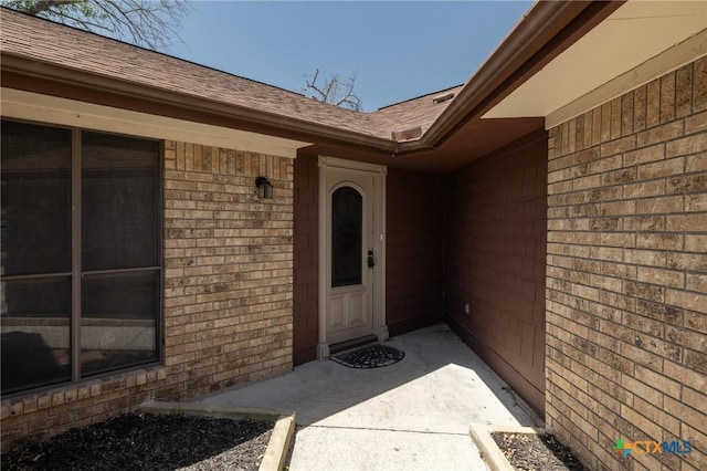 1008 Woodshadows Dr, Harker Heights, TX 76548 - property entrance featuring a shingled roof and brick siding