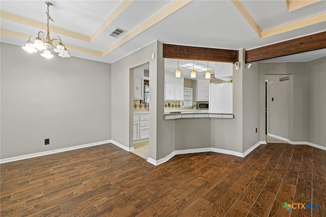1008 Woodshadows Dr, Harker Heights, TX 76548 - empty room featuring a tray ceiling, wood finished floors, and a chandelier