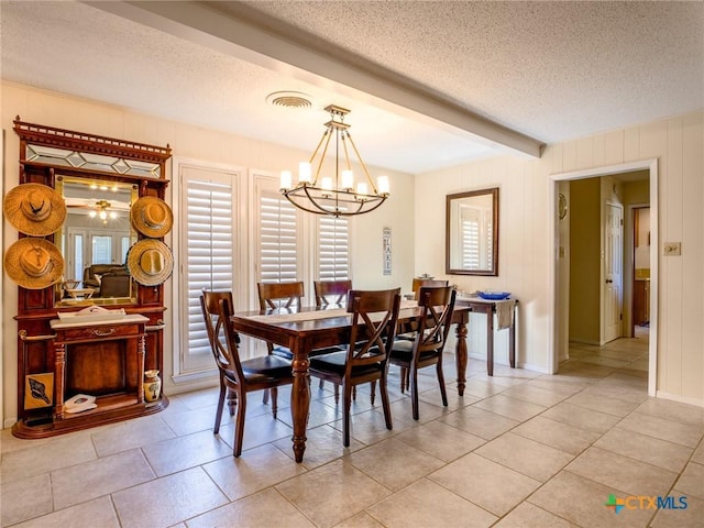 106 Flamingo Cir, Marble Falls, TX 78654 - dining room with a textured ceiling, a chandelier, light tile patterned flooring, and beam ceiling