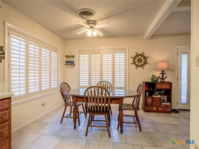 106 Flamingo Cir, Marble Falls, TX 78654 - dining area featuring a ceiling fan, a textured ceiling, light tile patterned flooring, and baseboards