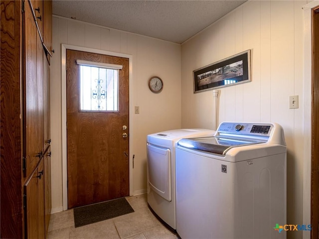 106 Flamingo Cir, Marble Falls, TX 78654 - clothes washing area featuring separate washer and dryer, light tile patterned flooring, and a textured ceiling