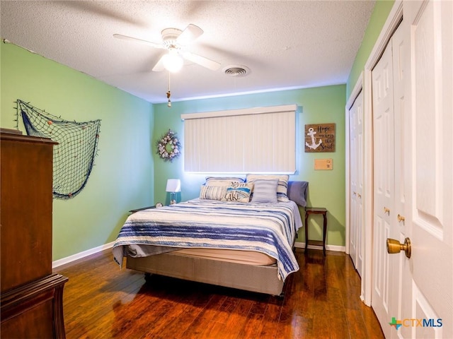 106 Flamingo Cir, Marble Falls, TX 78654 - bedroom featuring wood finished floors, baseboards, a textured ceiling, ceiling fan, and a closet