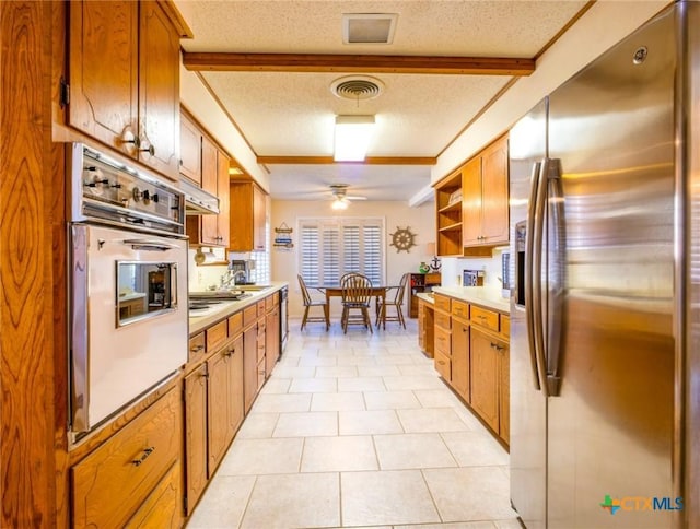 106 Flamingo Cir, Marble Falls, TX 78654 - kitchen with stainless steel refrigerator with ice dispenser, white oven, ceiling fan, light countertops, and a textured ceiling