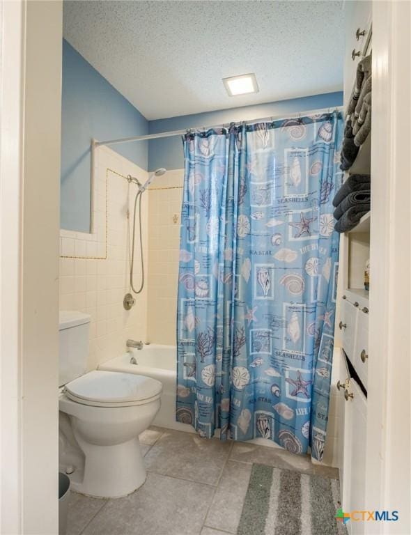 106 Flamingo Cir, Marble Falls, TX 78654 - full bathroom with shower / bath combo, a textured ceiling, tile patterned floors, toilet, and tile walls