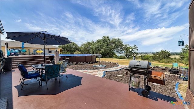 view of patio with grilling area and a fire pit