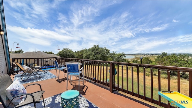 balcony featuring a water view