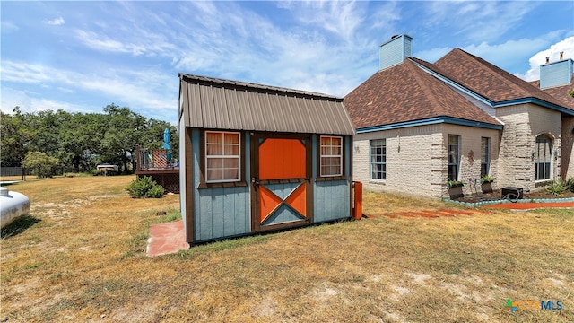 view of outdoor structure featuring a lawn