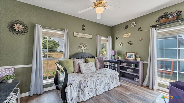 bedroom with hardwood / wood-style flooring and ceiling fan