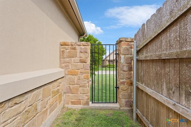 view of gate with fence