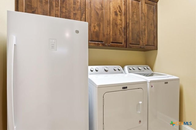 laundry area featuring cabinet space and washer and clothes dryer