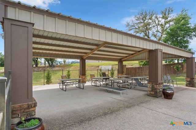 view of property's community featuring a gazebo, fence, and a patio area