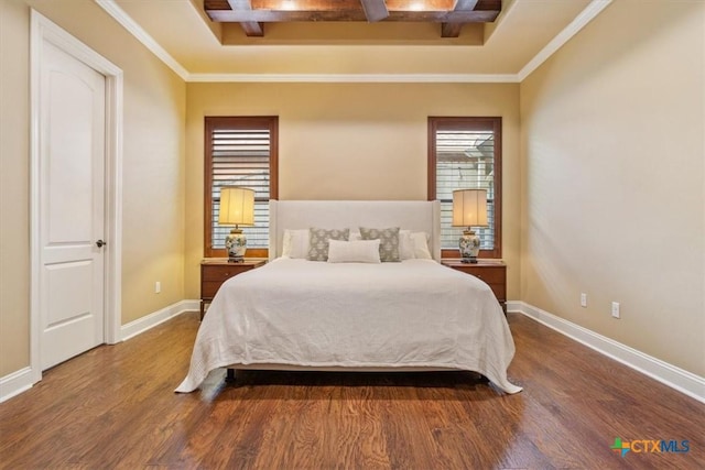 bedroom with baseboards, wood finished floors, and crown molding