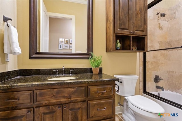 bathroom featuring bathtub / shower combination, vanity, and toilet